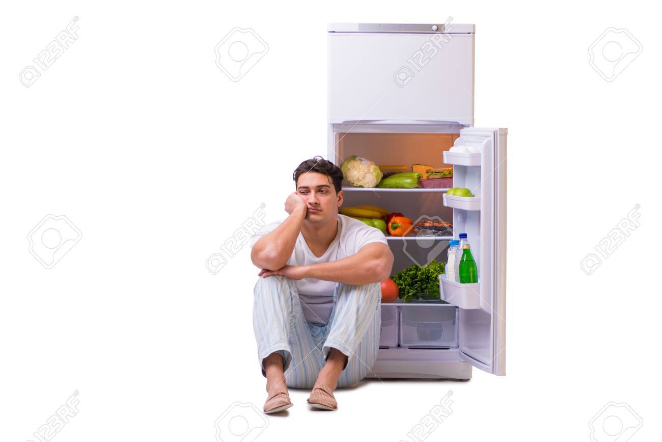 82234560-man-next-to-fridge-full-of-food.jpg